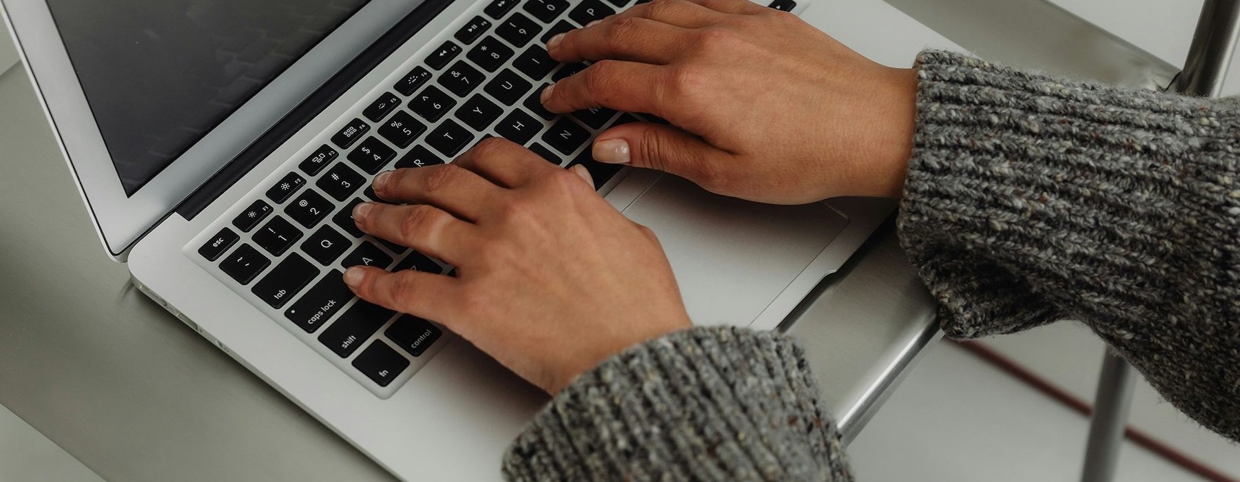 A person typing on a laptop