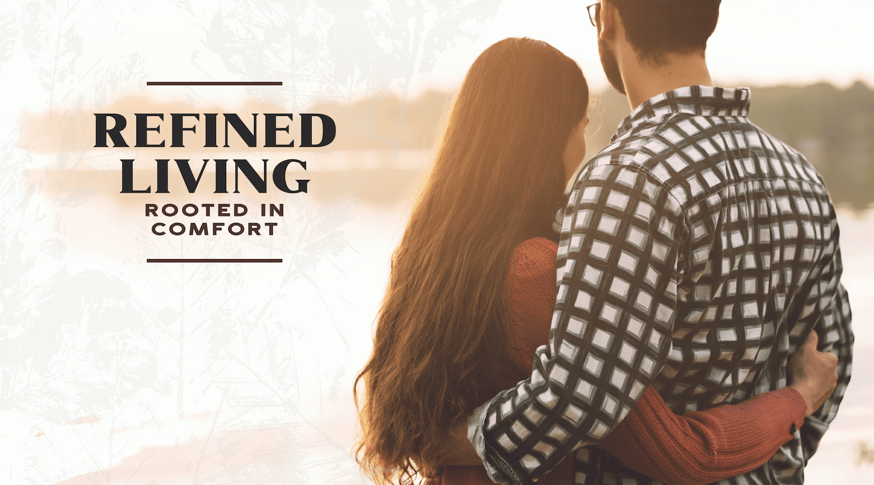 a man and a woman embracing and looking at a lake